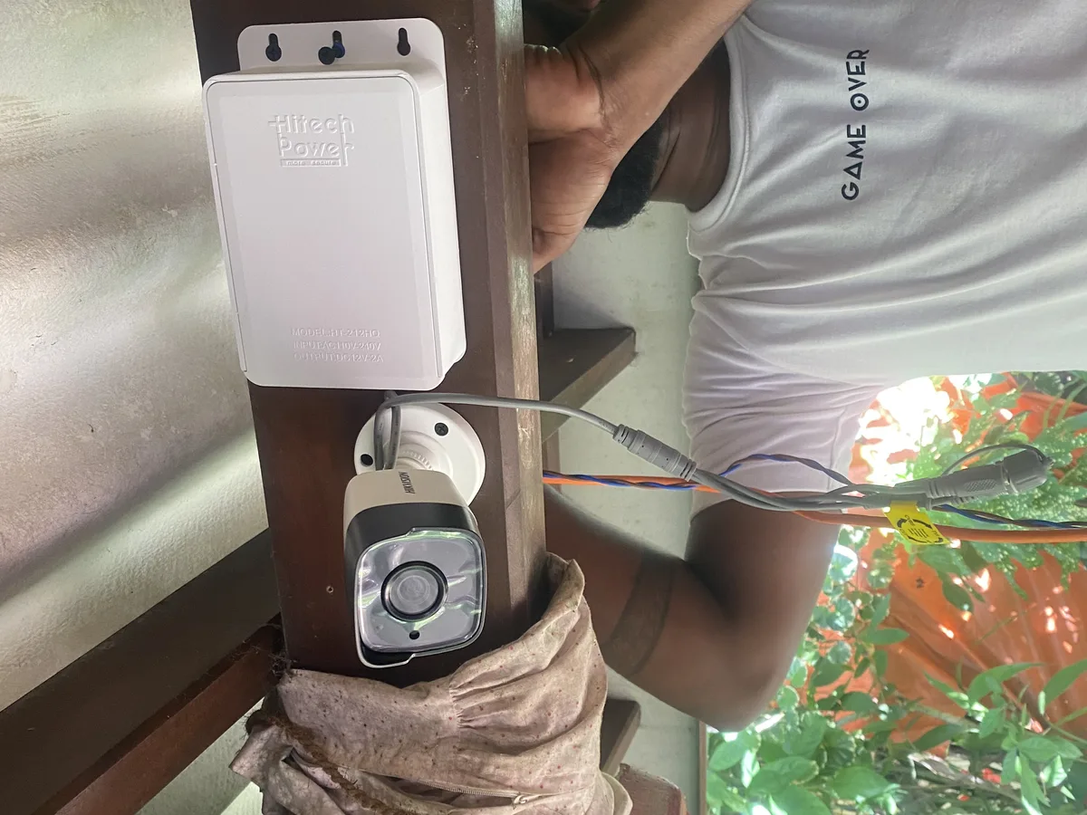 Technician installing an outdoor CCTV camera