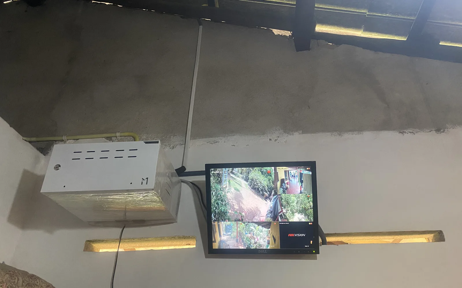 Installed CCTV recorder cabinet and live multi-camera monitor